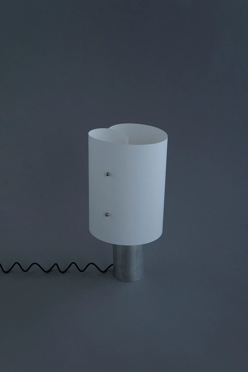 Curly table lamp, curled washi paper shade on a cylindrical aluminum base with a coiled black cord